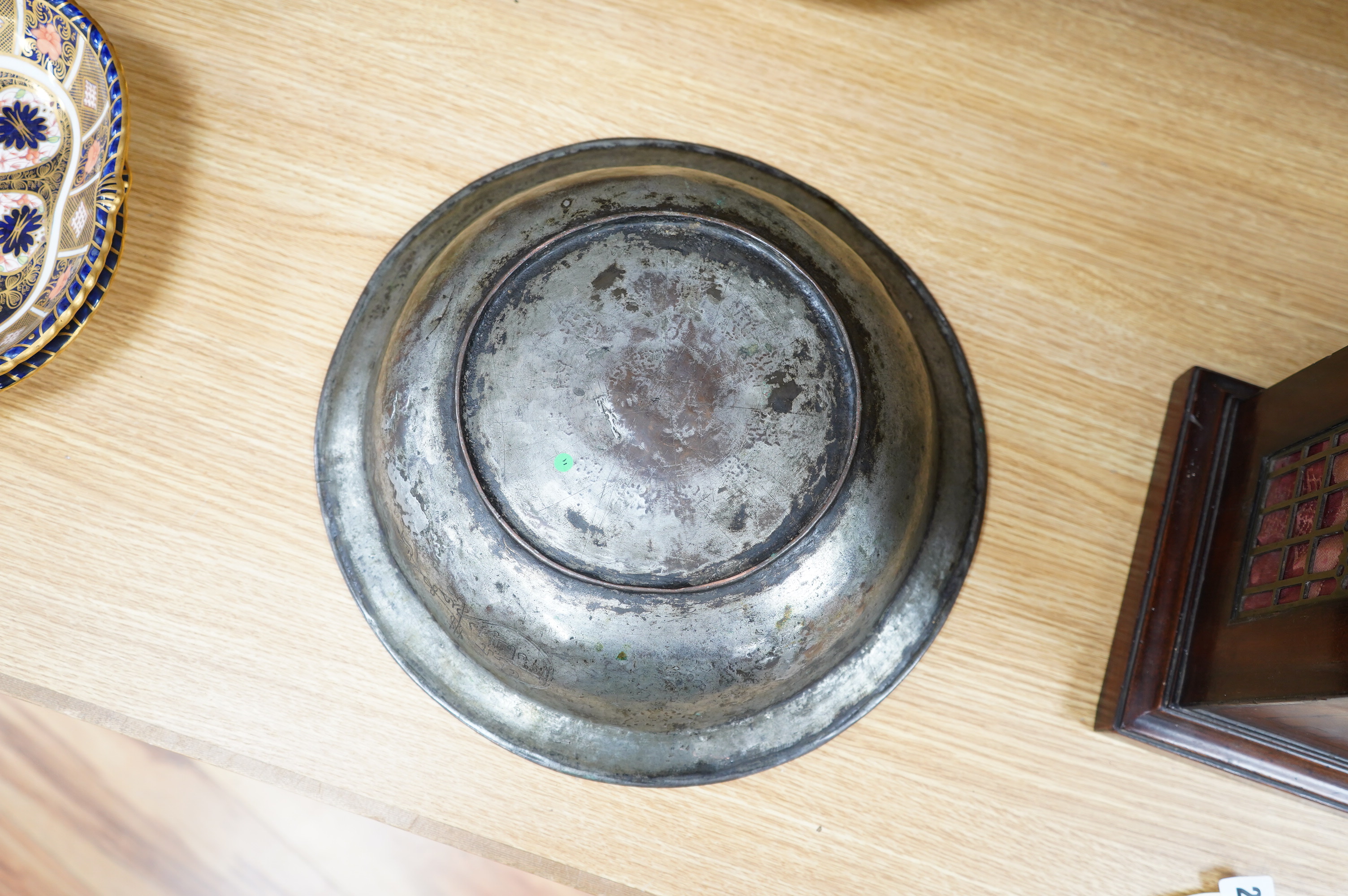 A Safavid tinned copper bowl engraved with a goat and flowers, 32cm diameter. Condition - fair